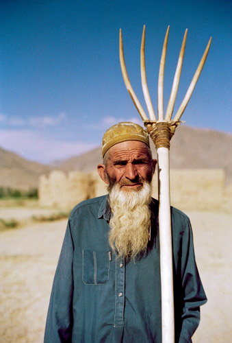 Afghan farmer poses with pitchfork
